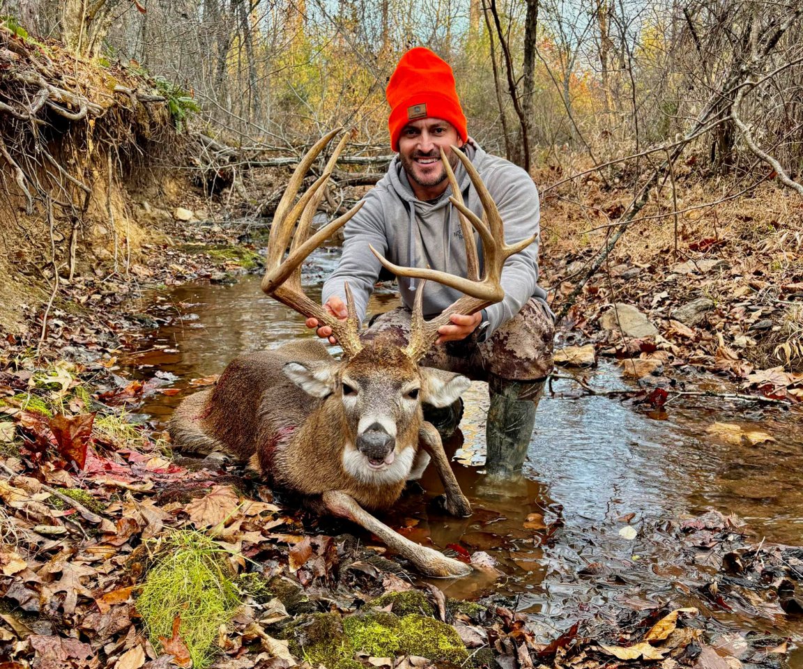 A hunter holds up a big Virginia buck.