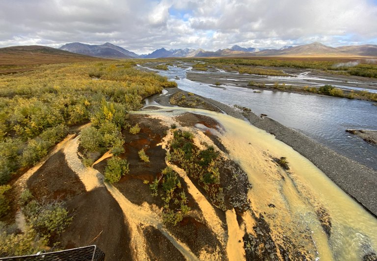 A river in Alaska runs orange due to pollution.