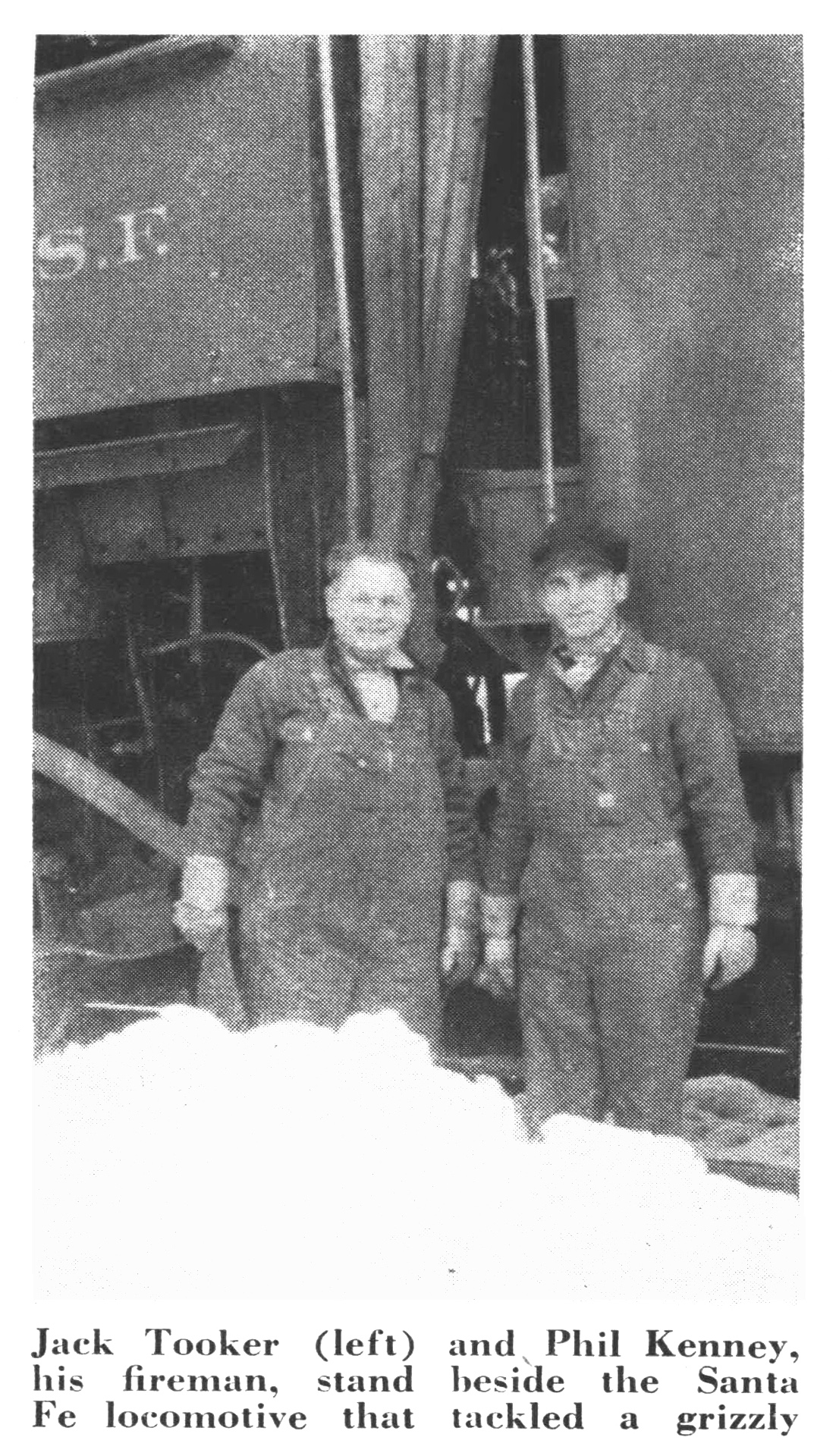 A black and white photo of two train employees