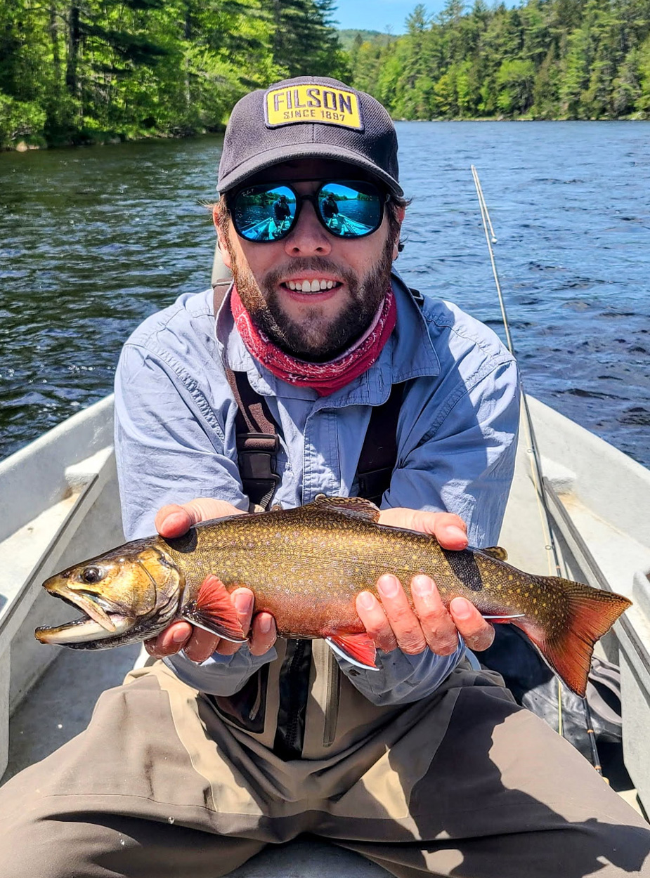 A fly angler with a brook trout.