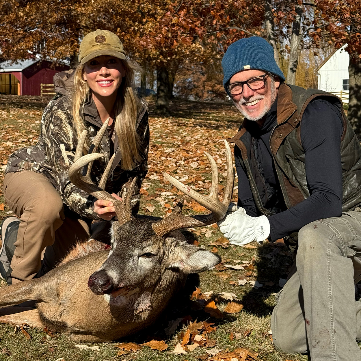 A hunter and her dad with a big Wisconsin buck.