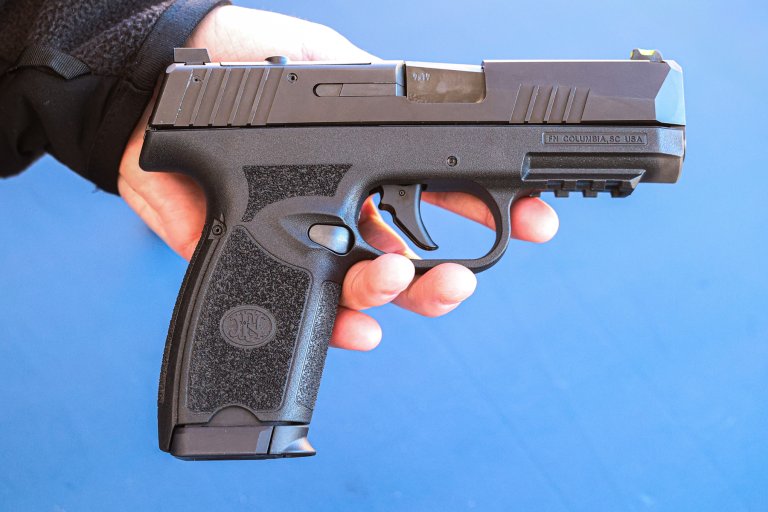 The FN 309 handgun on a blue background