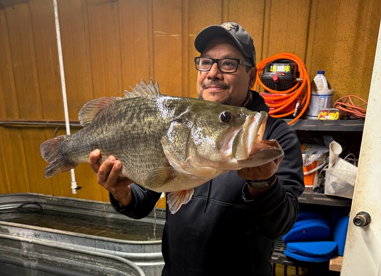 An angler holds up a huge Texas bass.