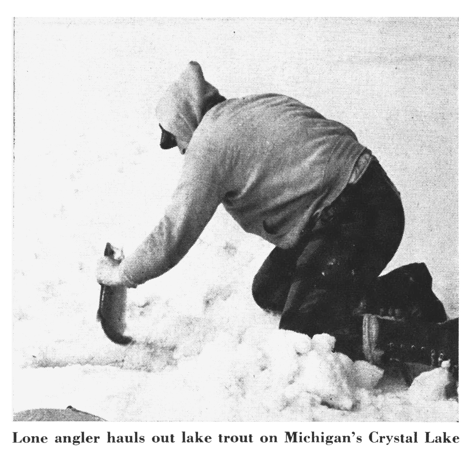 A black and white photo of a man grabbing a fish out of the ice.