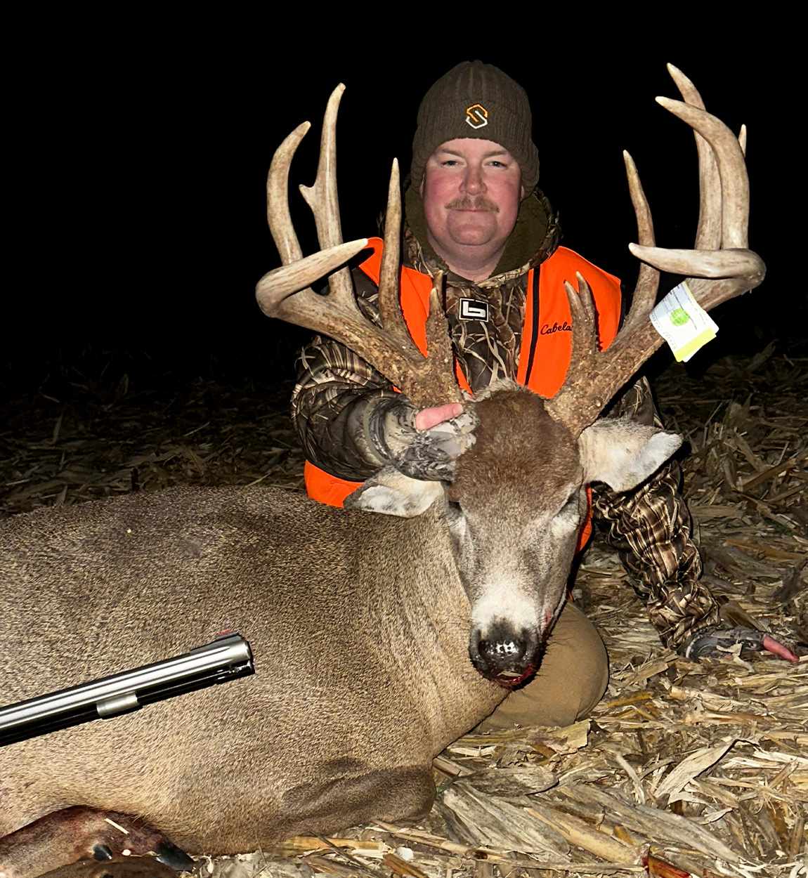 A muzzleloader hunter with a big Iowa buck.