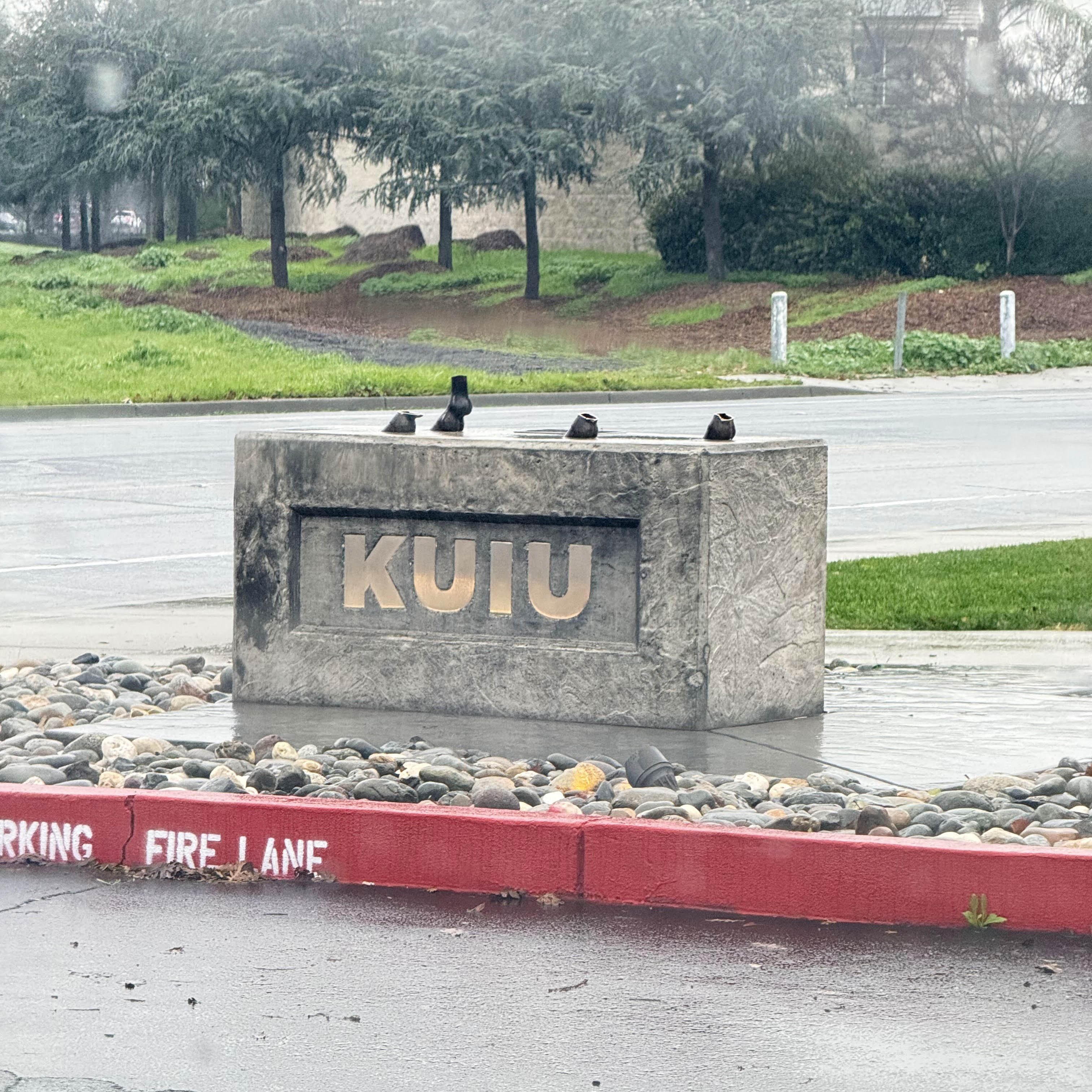 A photo of the kuiu headquarters sign with the missing bronze sheep statute.