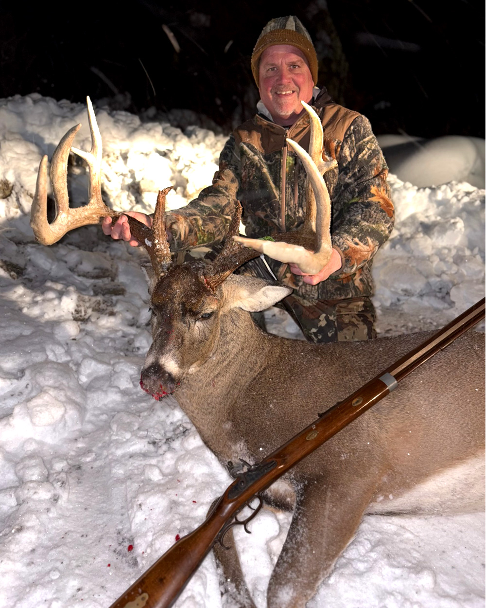 A deer hunter with a big buck he tagged in Pennsylvania.
