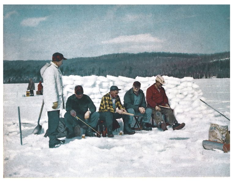 A color photograph of ice fisherman behind an igloo.