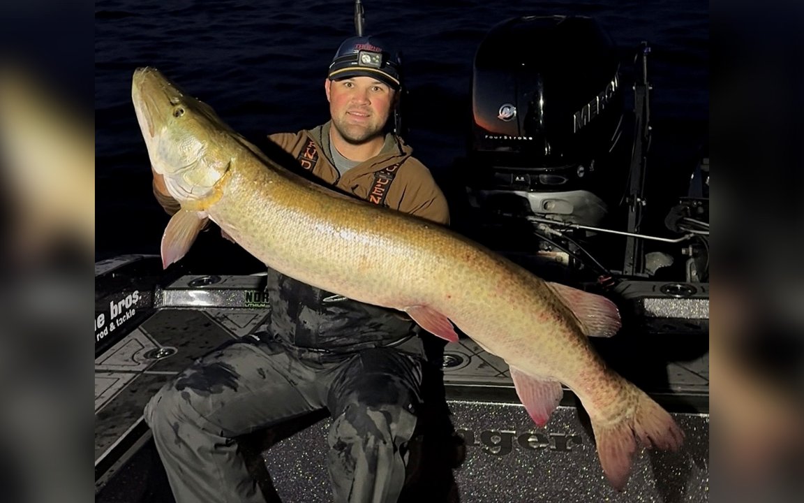 An angler with a big muskie caught from Green Bay.
