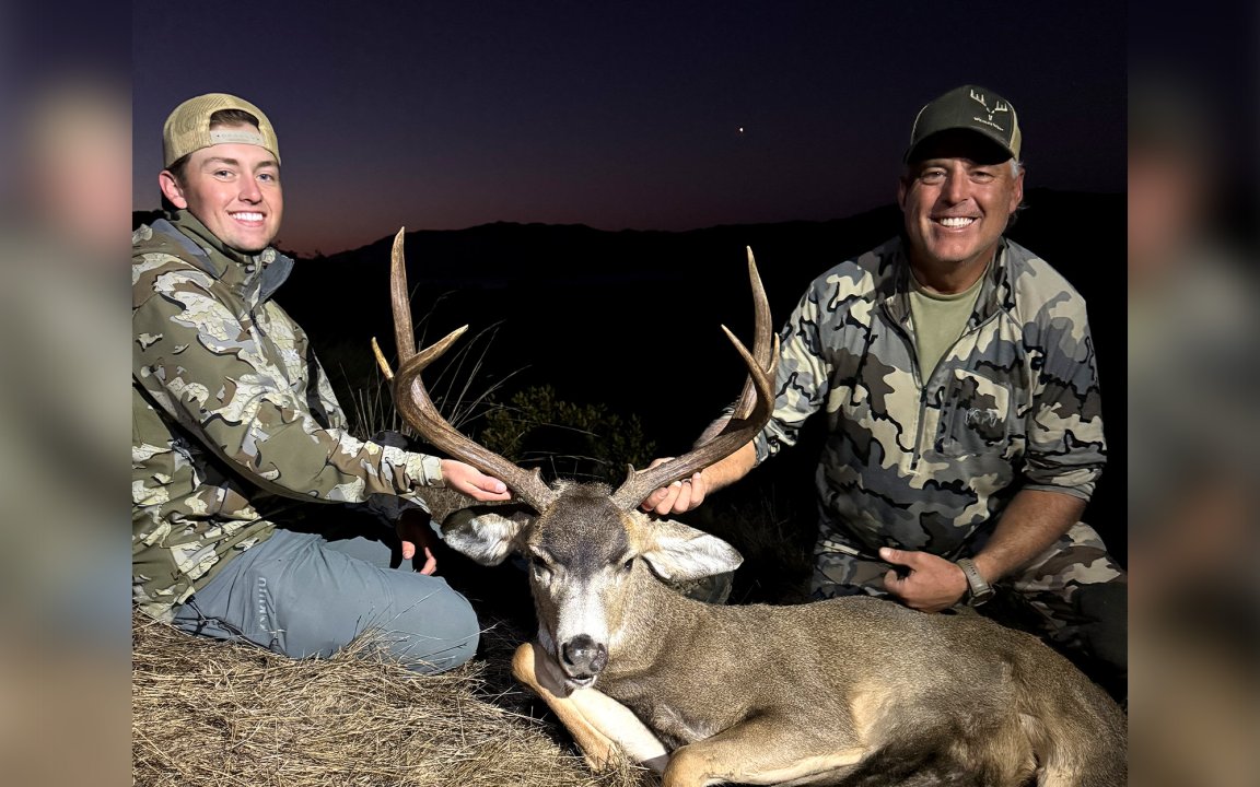 Two California hunters with a mule deer buck.