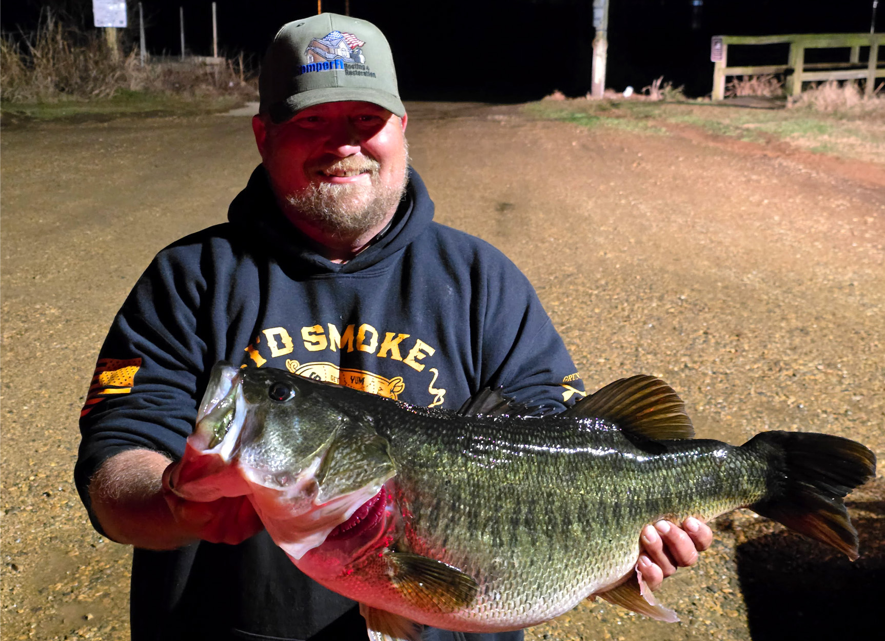 A Texas bass fisherman holds up a big largemouth.