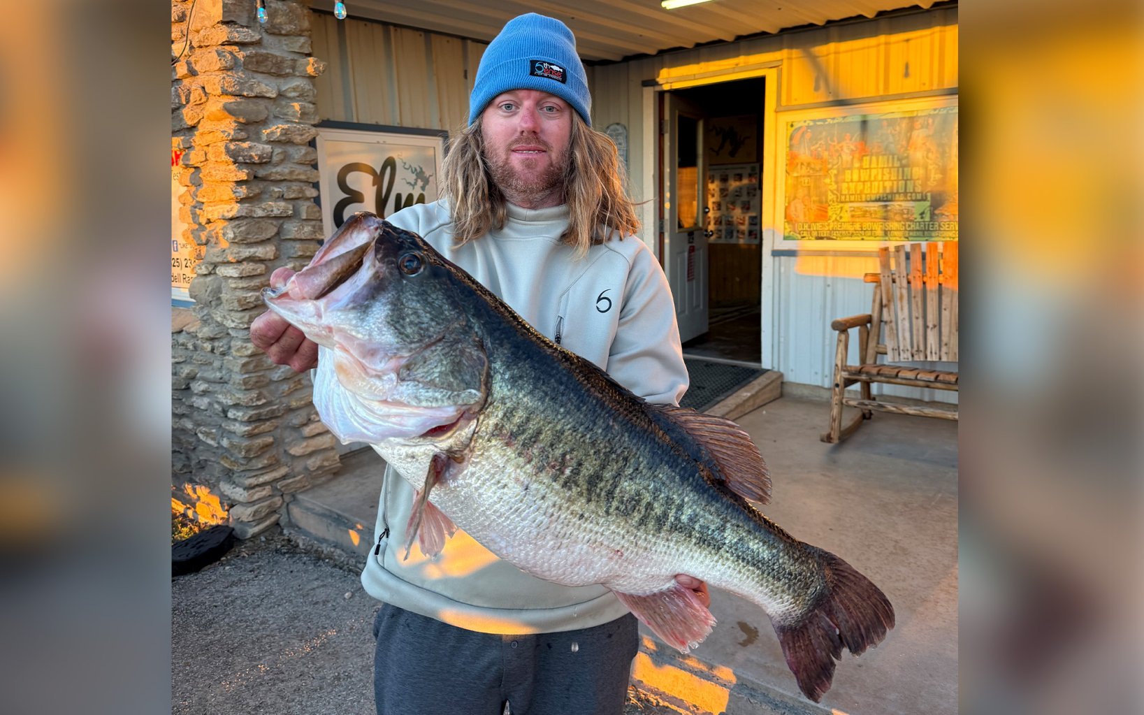 A fishing guide with a massive largemouth bass.