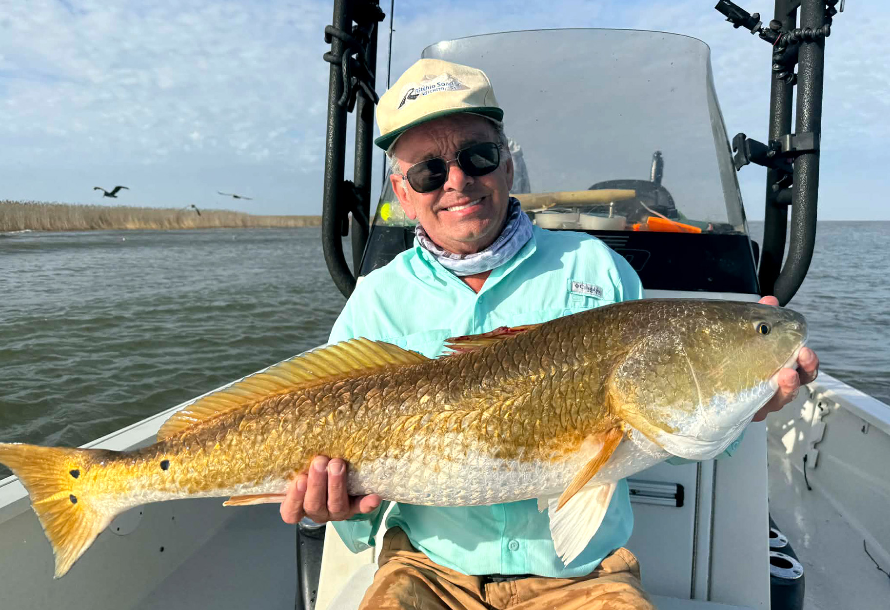 A fisherman with a big Louisiana redfish.