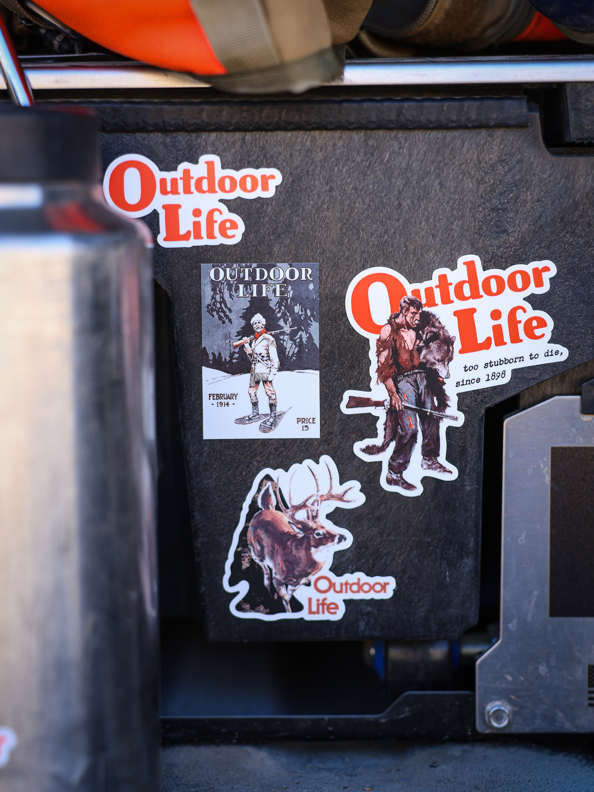 Four outdoor life die-cut stickers on a Decked drawer.