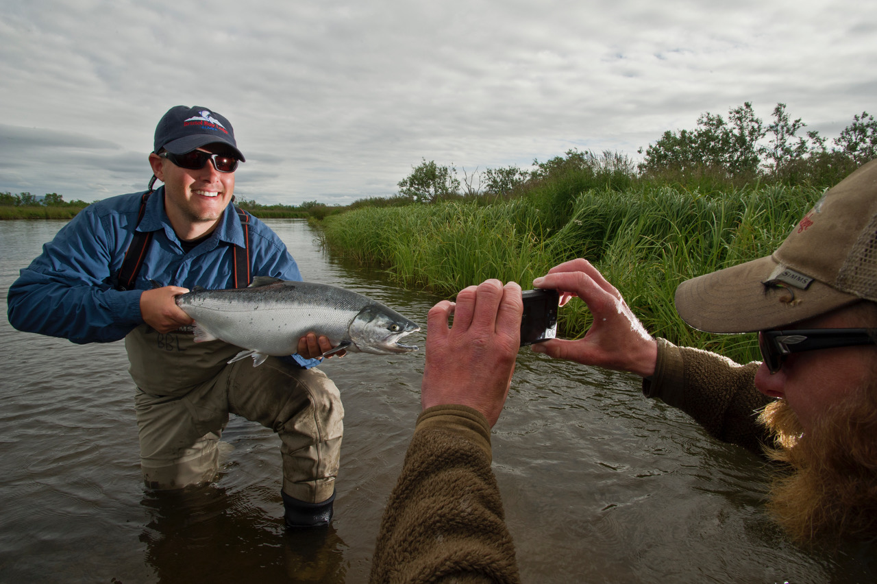 A photo of a guy holding up a fish