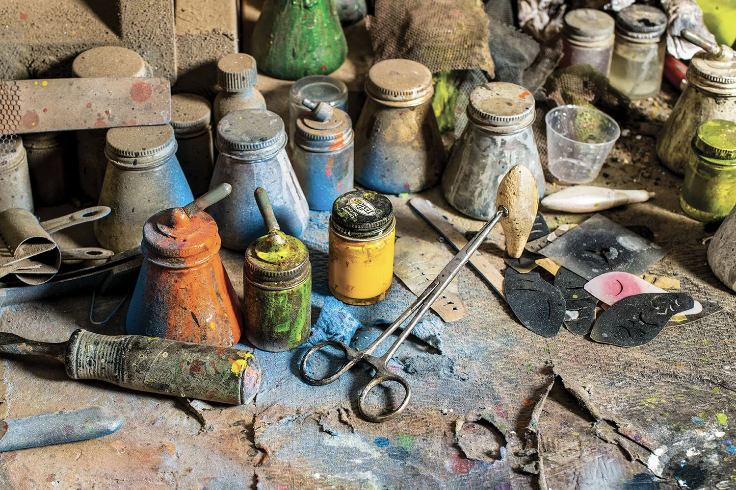 A messy paint and airbrush table.