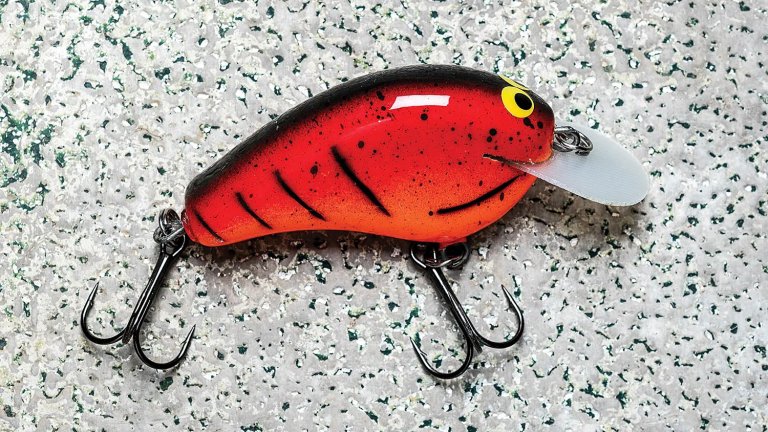close-up of single, finished red custom balsa crankbait