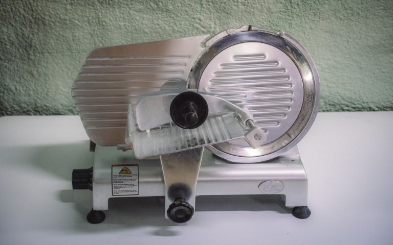The LEM meat slicer sits on a table, ready for use
