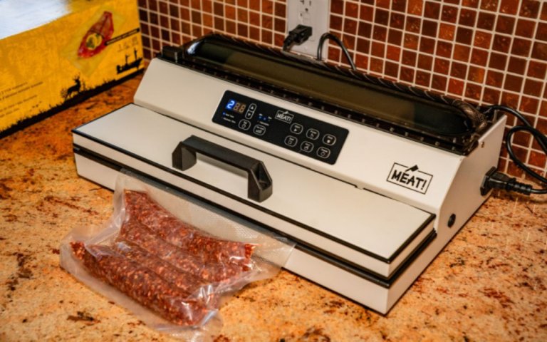 An external vacuum sealer in action sealing up a package of hot dogs.