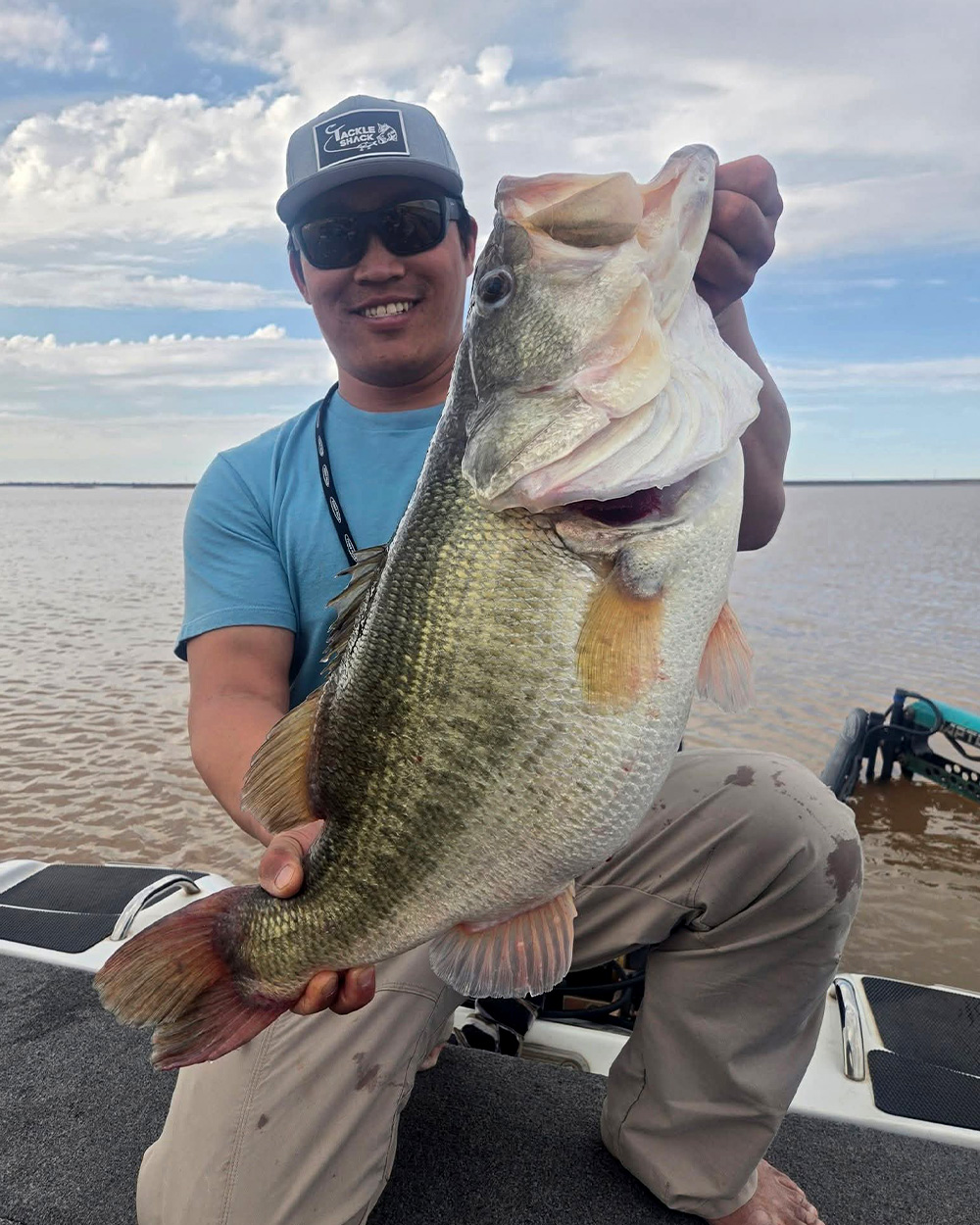 A bass angler holds up a huge largemouth.