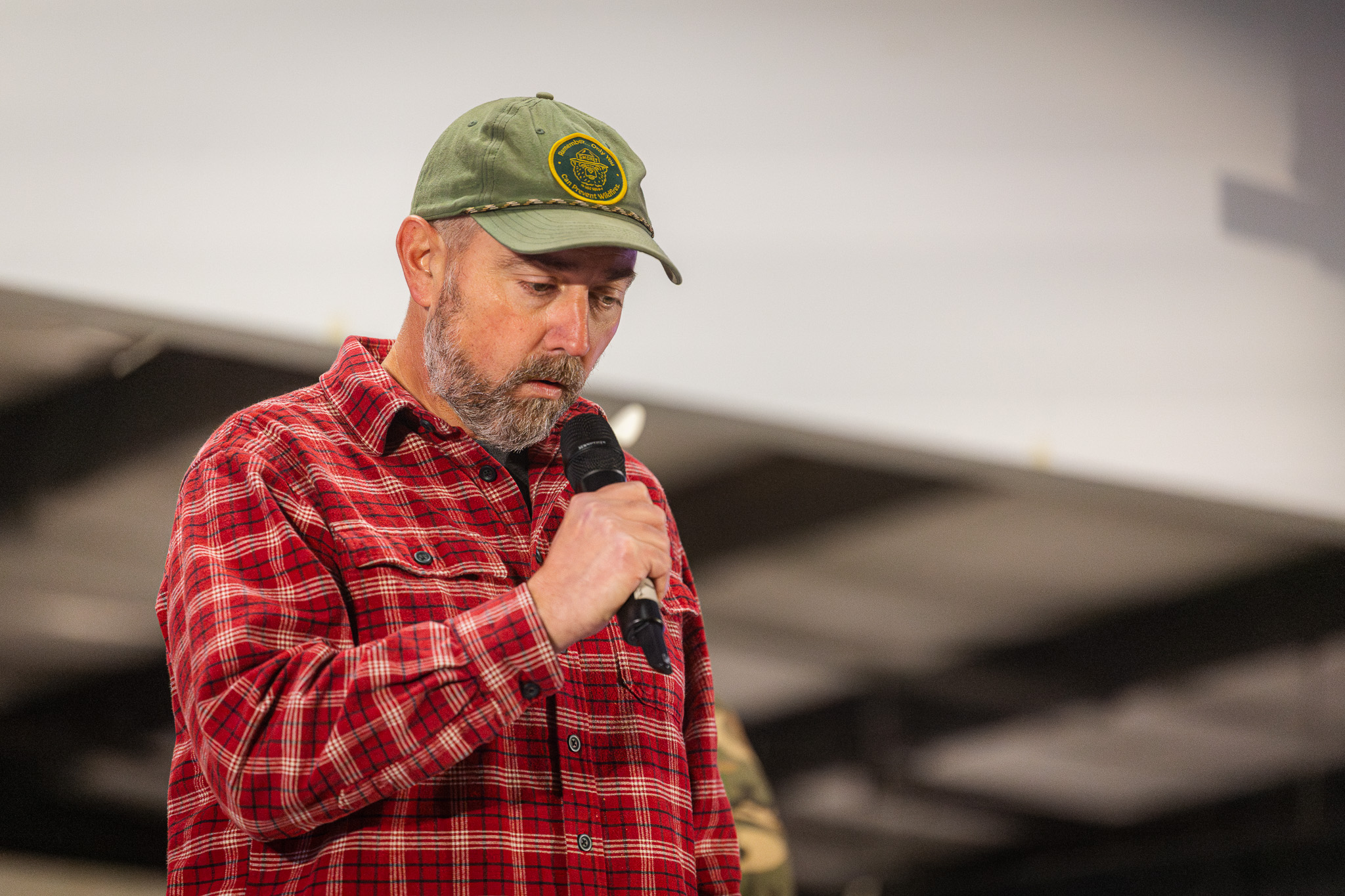 A man owl hoots into a microphone.