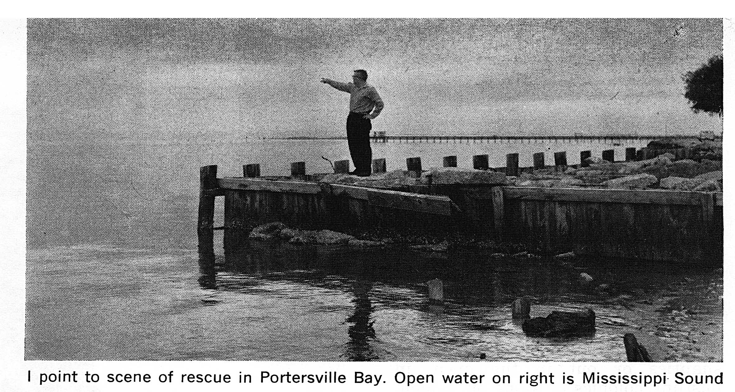 A black and white photo of a man pointing out to open gulf.