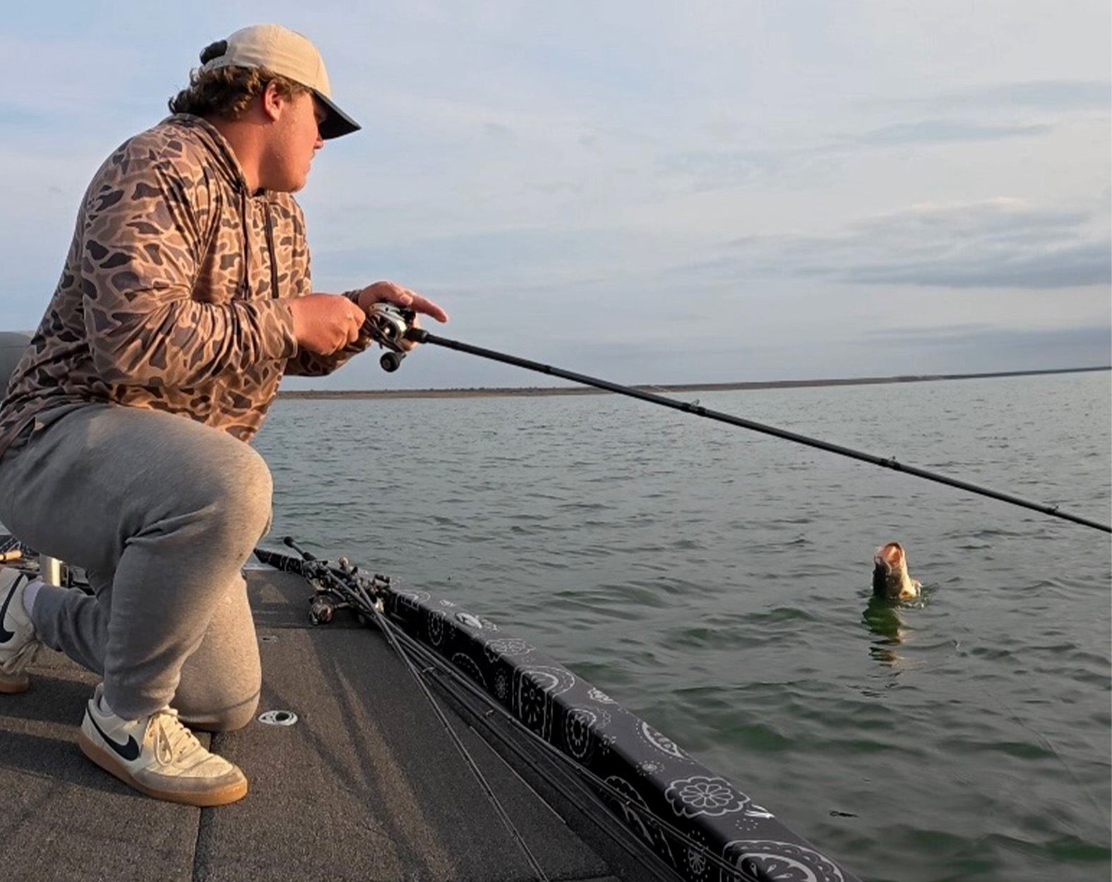 An angler plays a jumping bass.