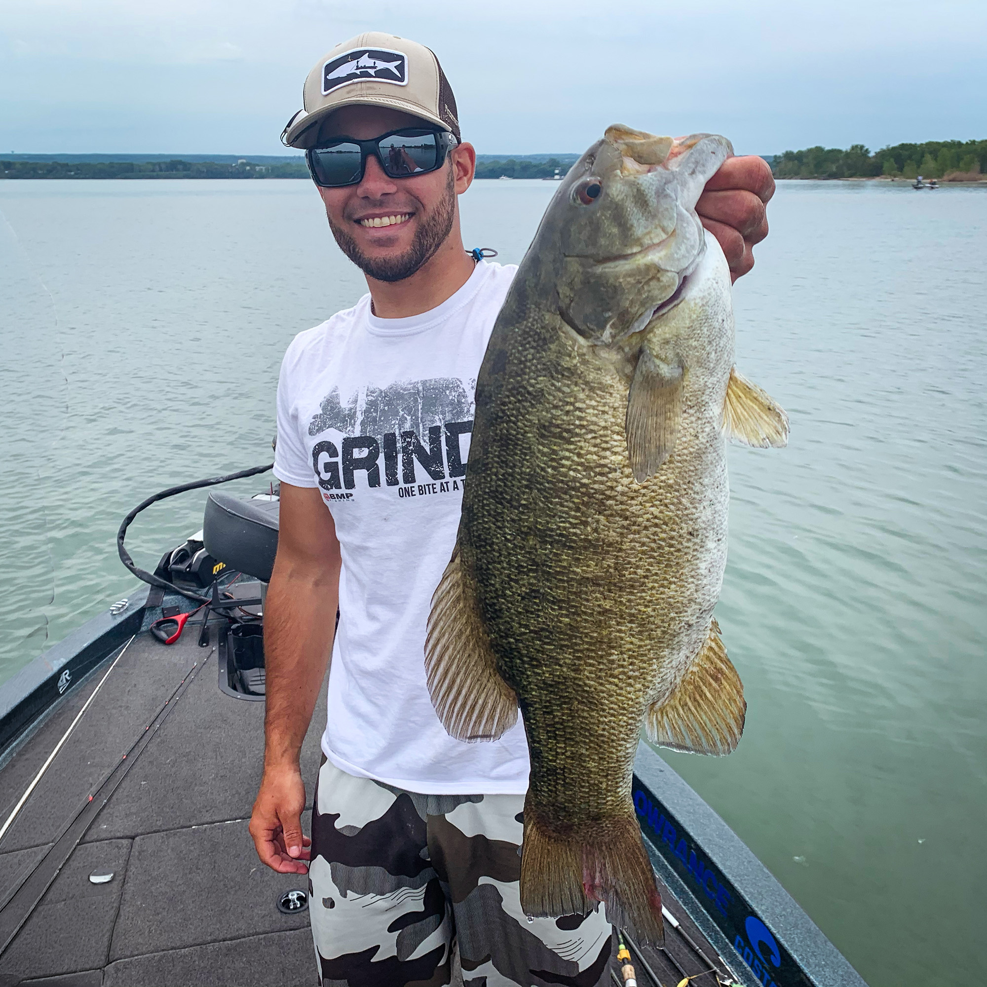 An angler holds up a huge smallmouth bass caught in the spring.
