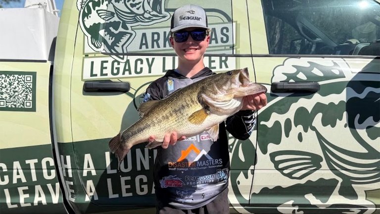A teen angler with a huge largemouth bass.