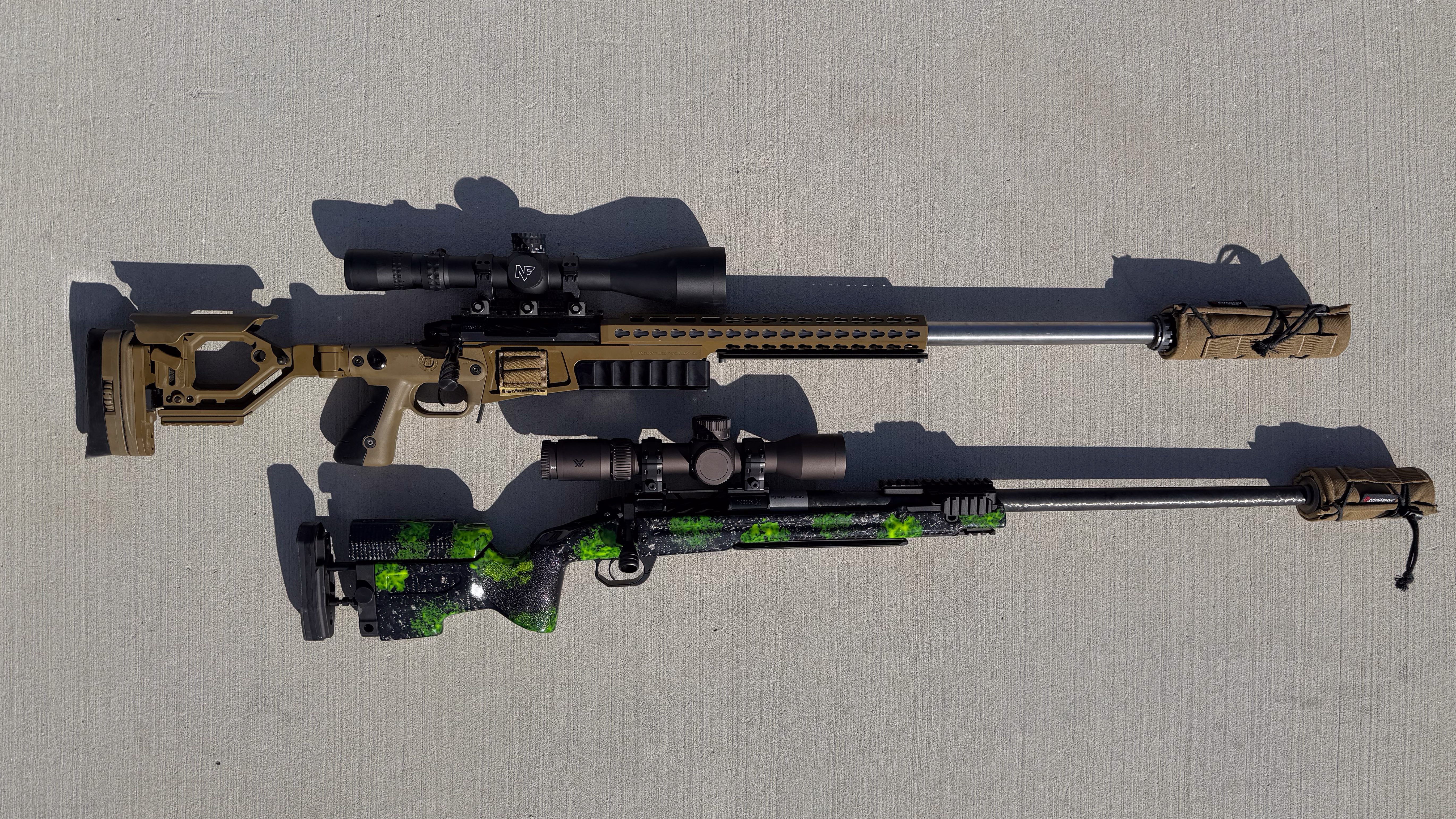 A pair of 25 caliber rifles on concrete