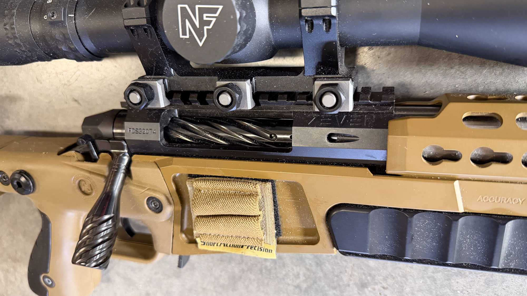 A closeup of a Falkor 7Even action, chambered in 25 Creed.