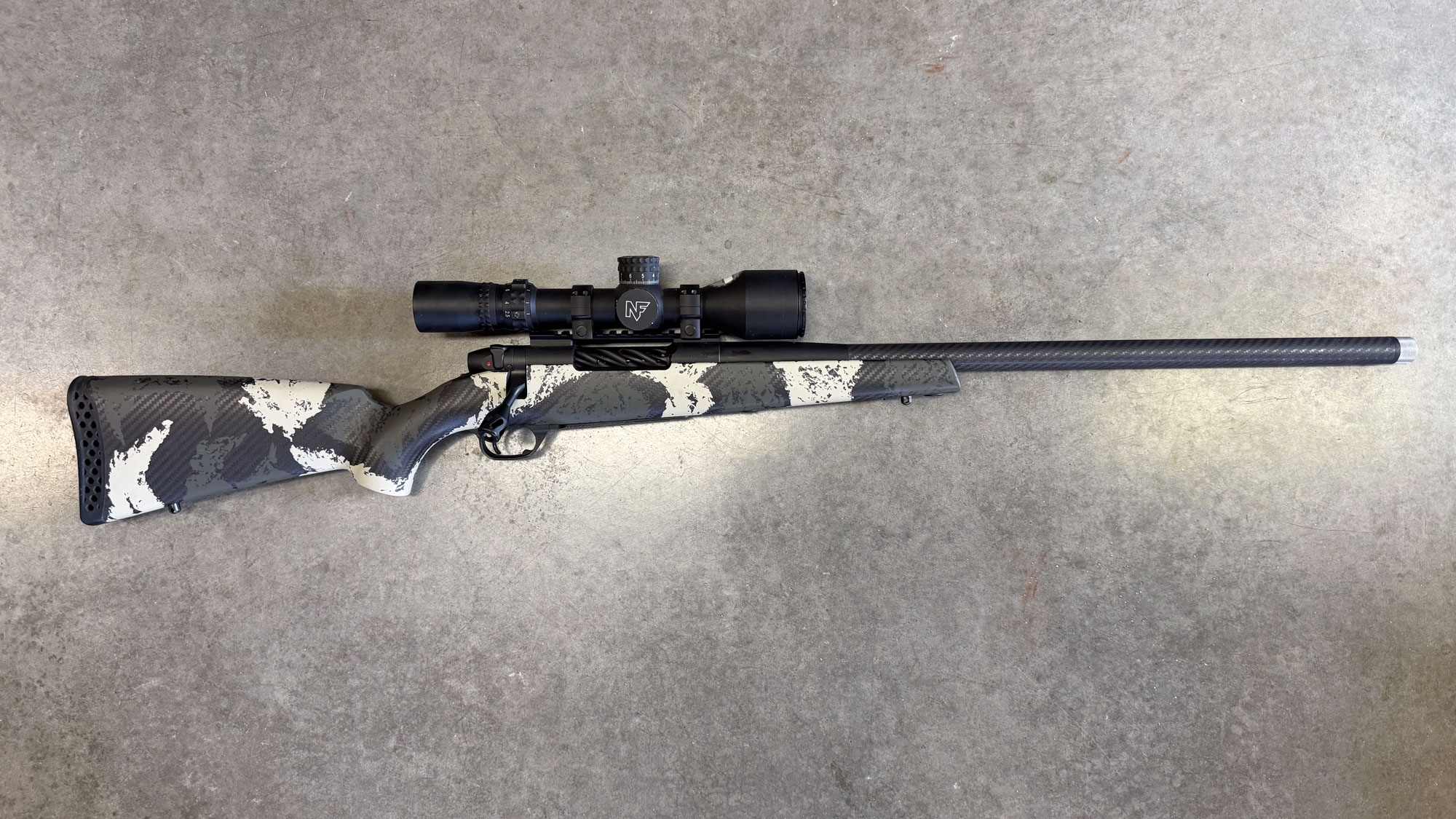 A black and white patterened Weatherby Mark V Backcountry Guide on concrete, chambered in .257 Weatherby Magnum