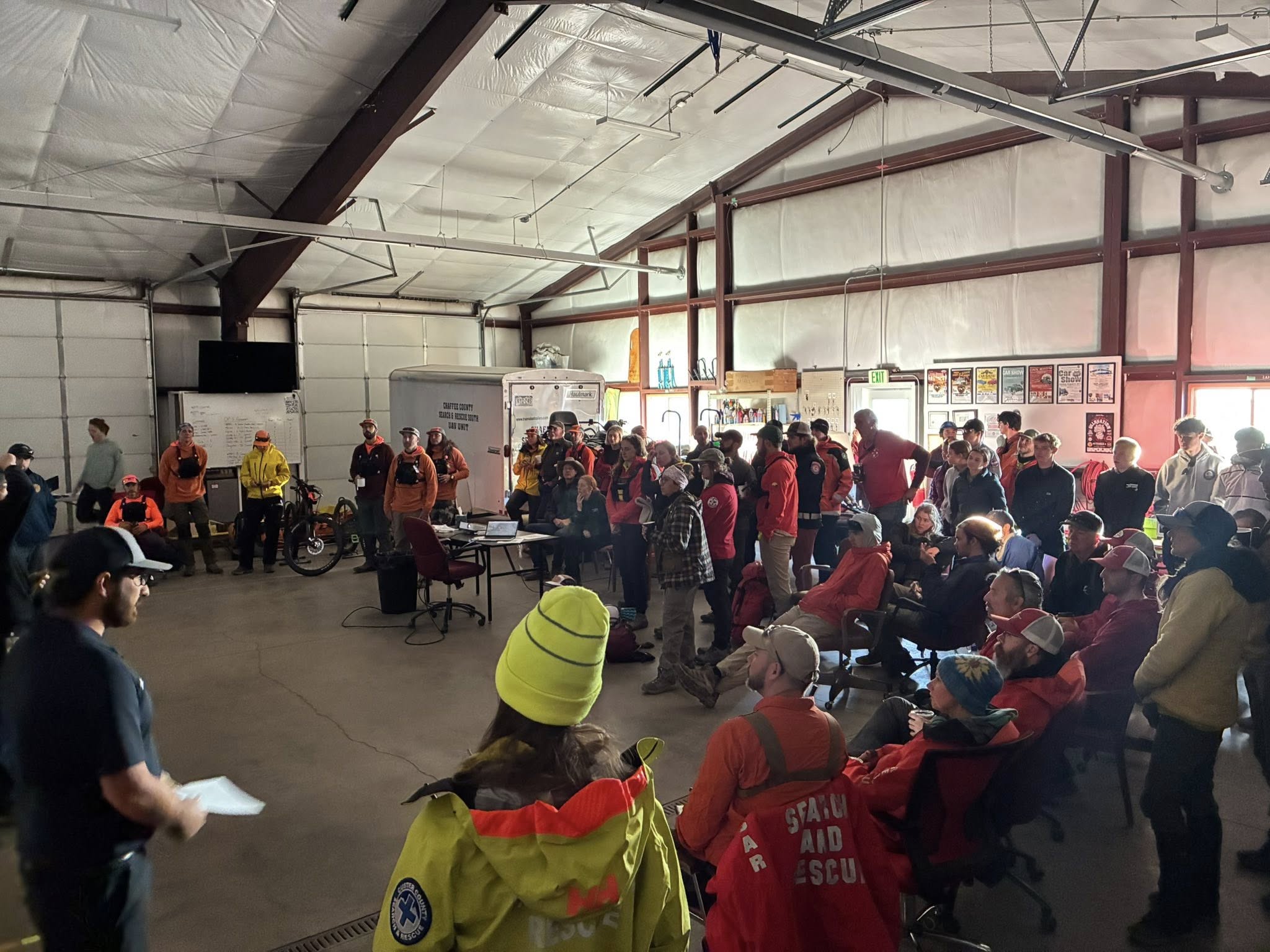 Search and rescue volunteers in a big room before searching for Kaden Sites.