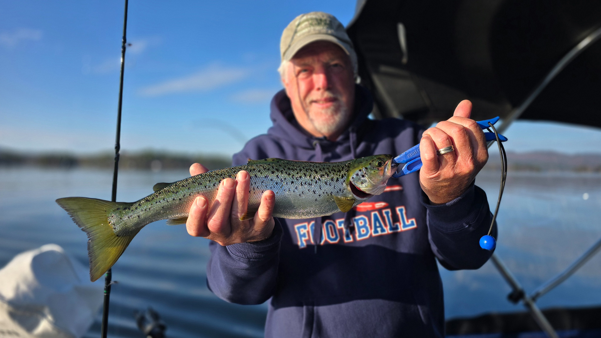 A man holds up a landlocked salmon