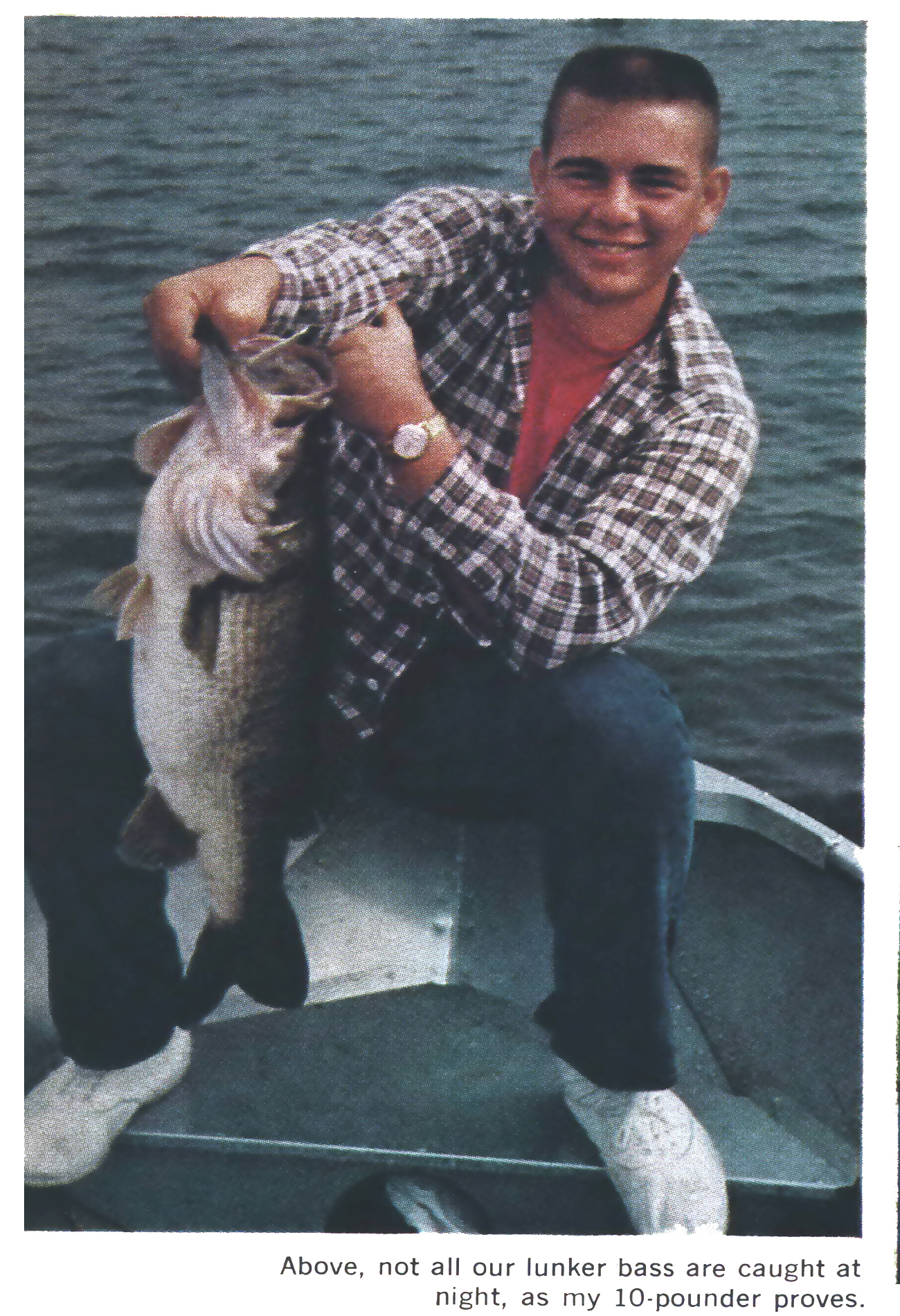 An old photo of a man holding up a 10 pound bass in a boat.