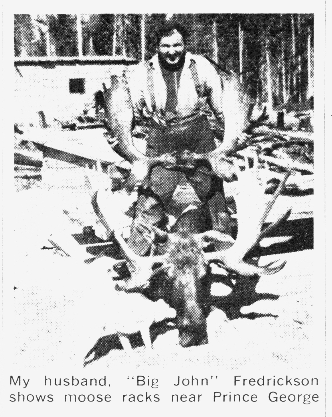 A black and white photo of a man with moose.