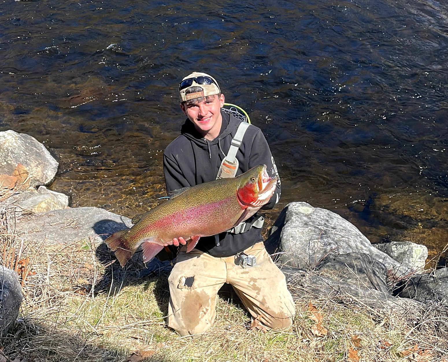 A trout angler with huge rainbow caught in Connecticut.