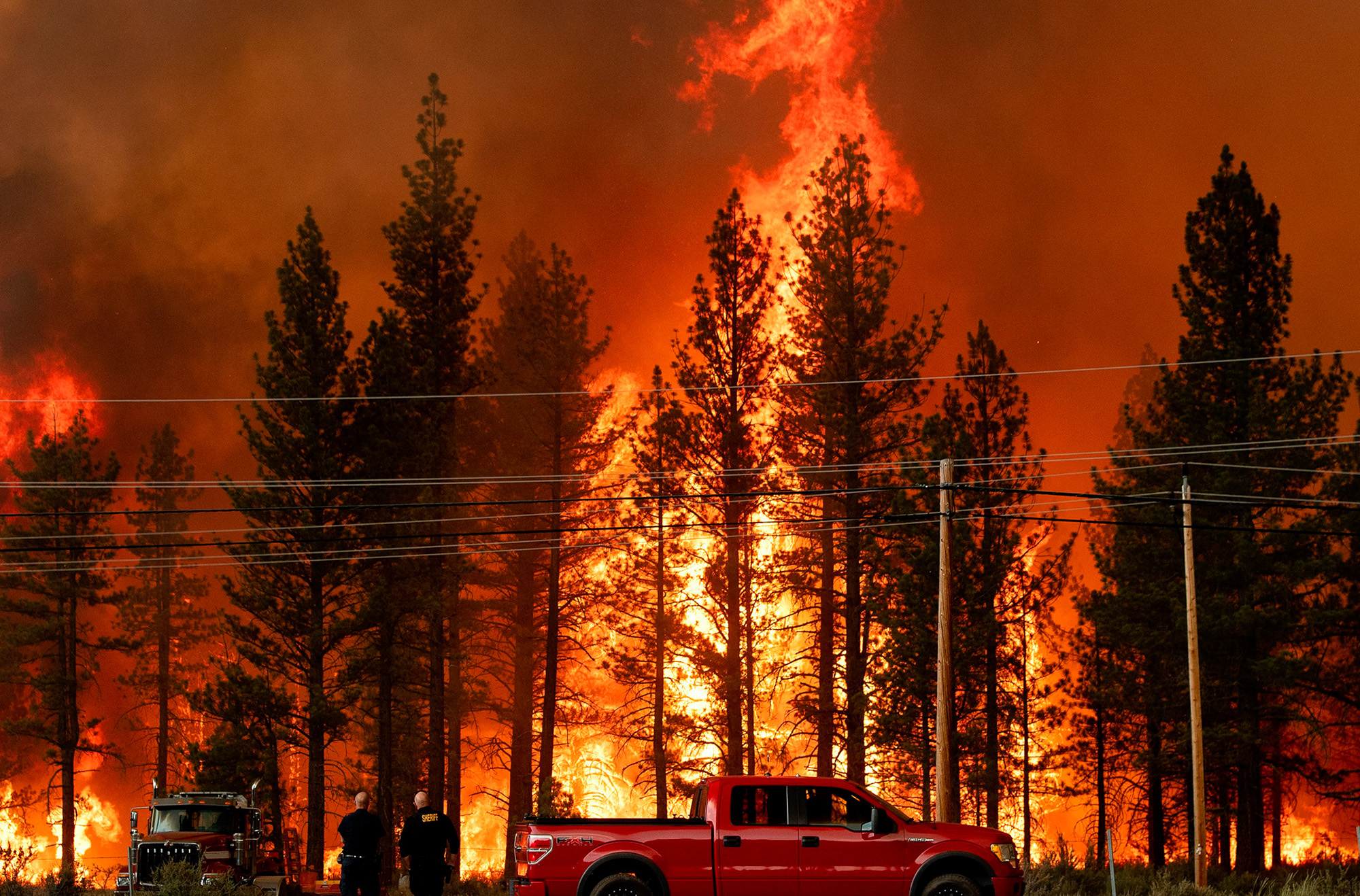Flames approach a highway in a California wildfire.