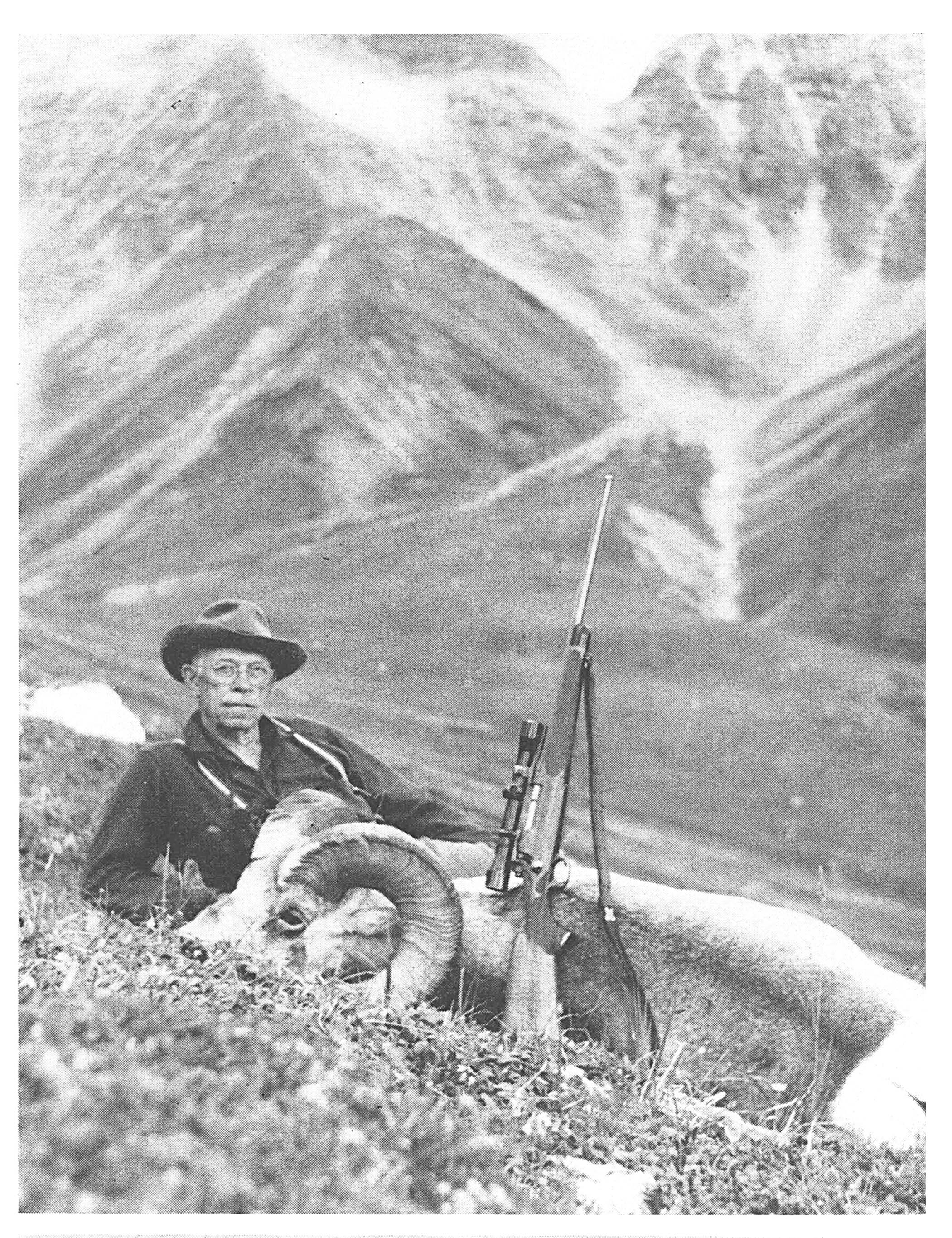 an old black and white photo of Jack O'Connor sitting on a hillside.