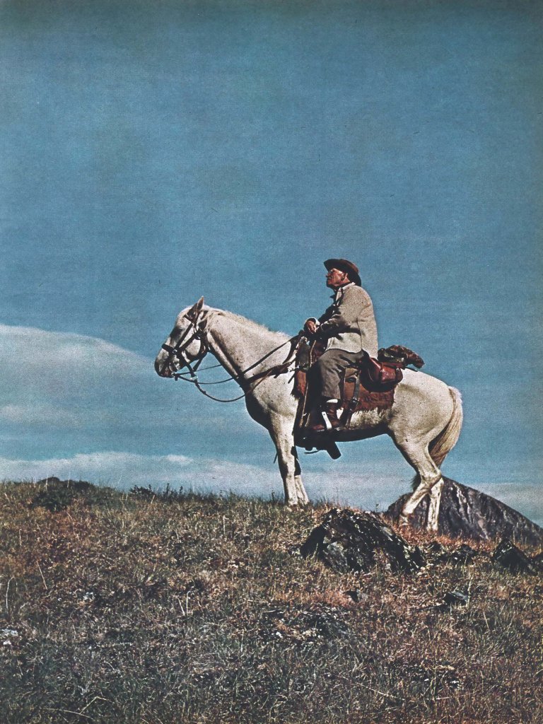 an old color photo of Jack O'Connor sits on horseback