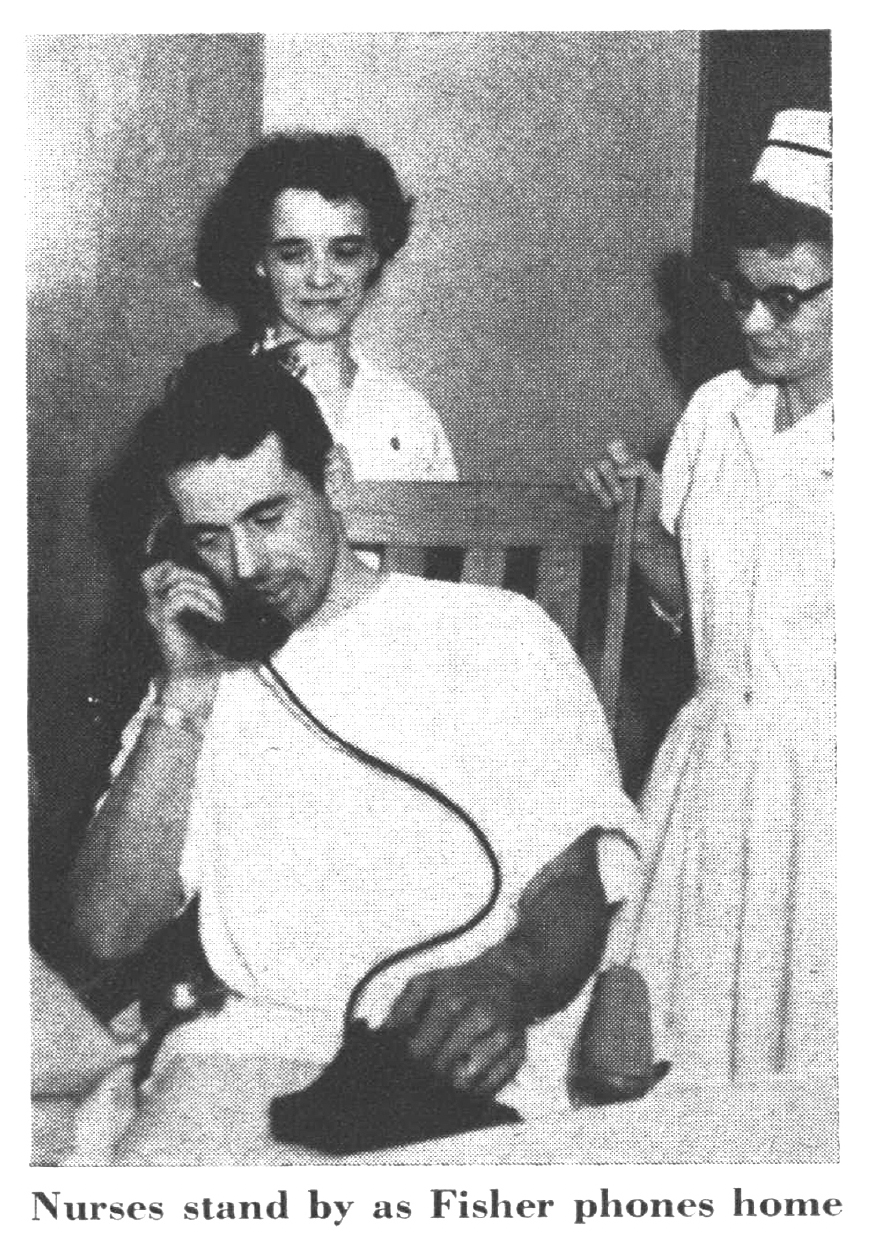 A black and white photo of a man on the phone.