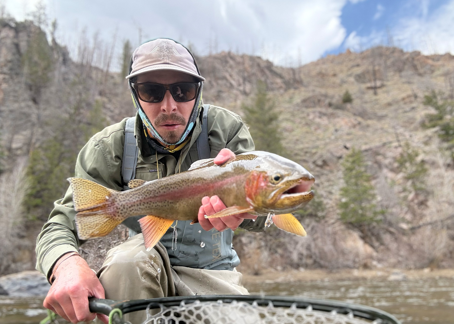 Author with a rainbow trout caught in Colorado.