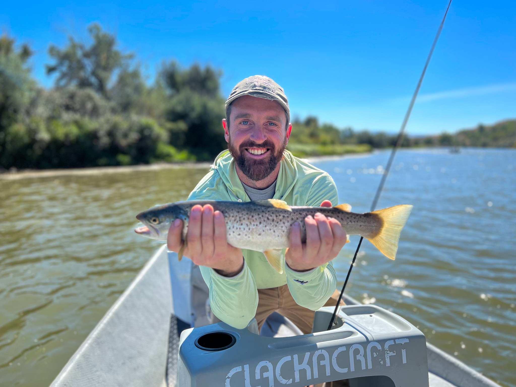 Zach Lentsch holds up a trout in wyoming