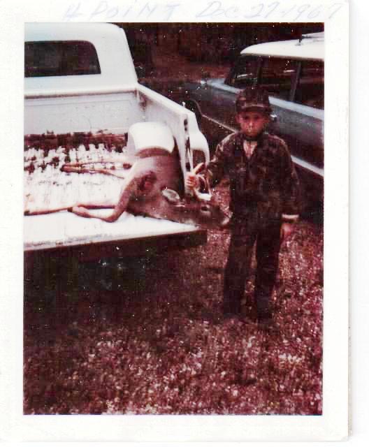 A vintage photo of a kid with a buck in the Kisatchie National Forest