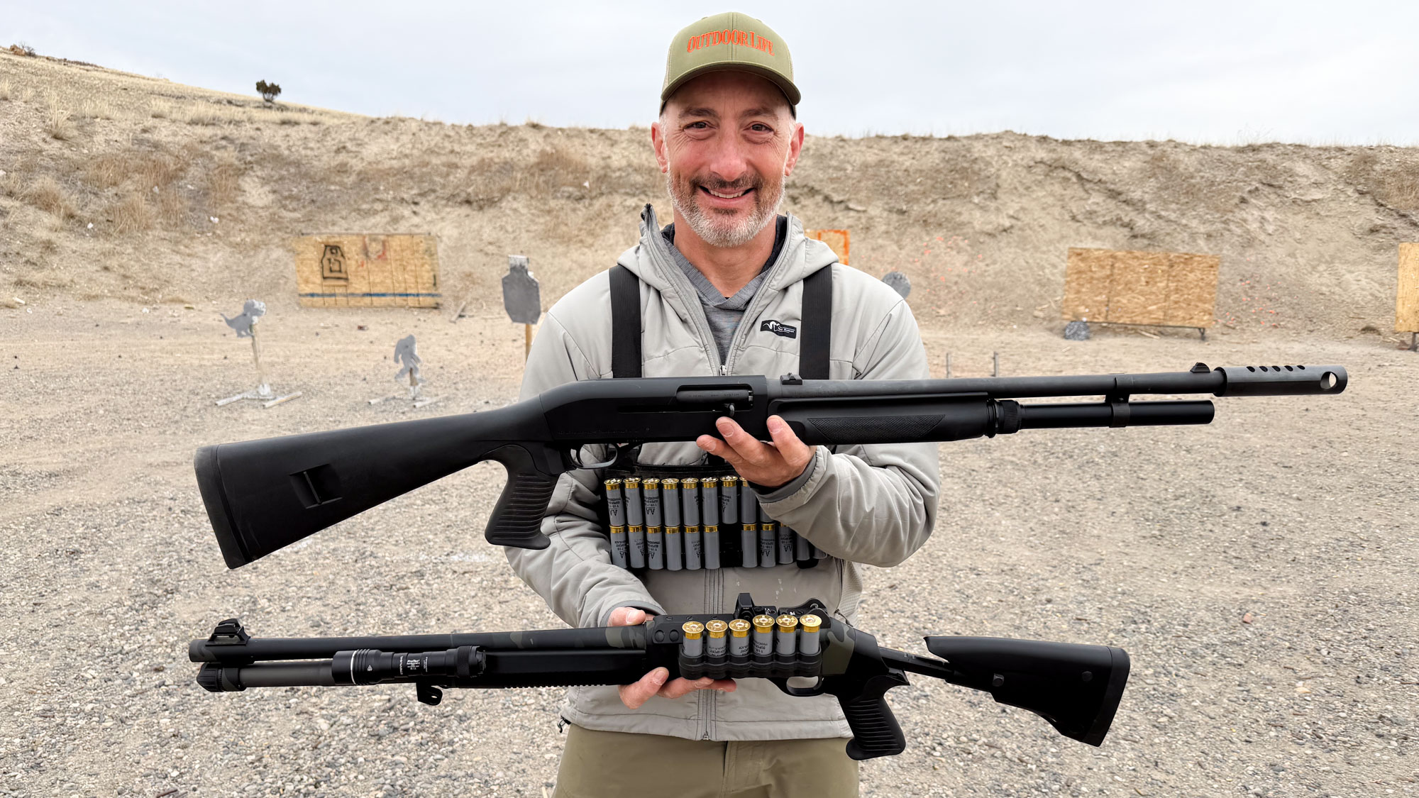 Author holding a Benelli M4 EXT in one hand and a M1 Super 90 in the other