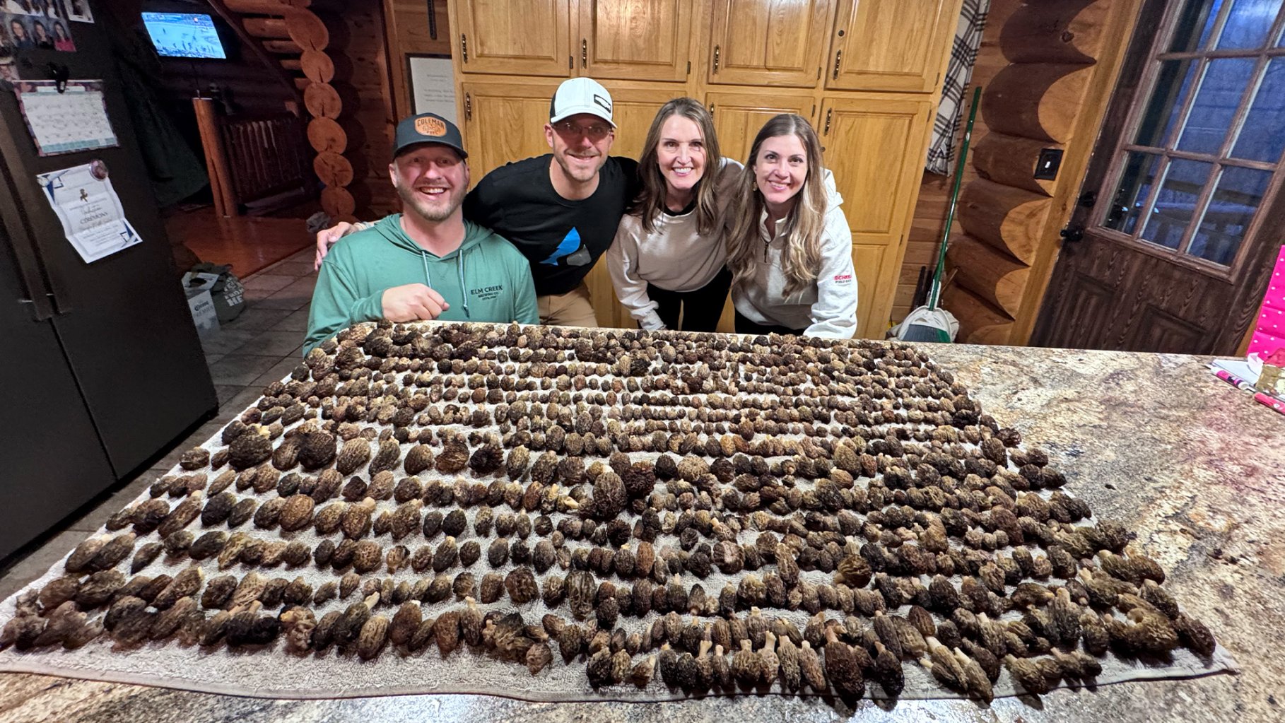 A group of foragers show off their morel harvest.