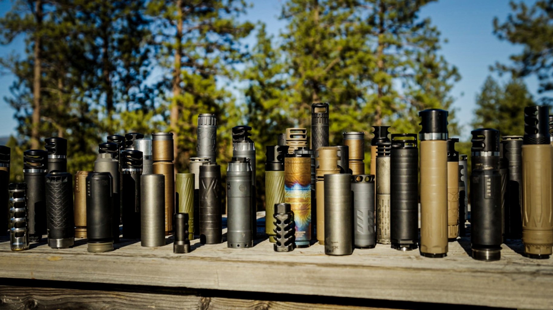 A bunch of suppressors on a table