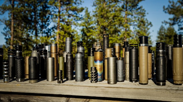 A bunch of suppressors on a table