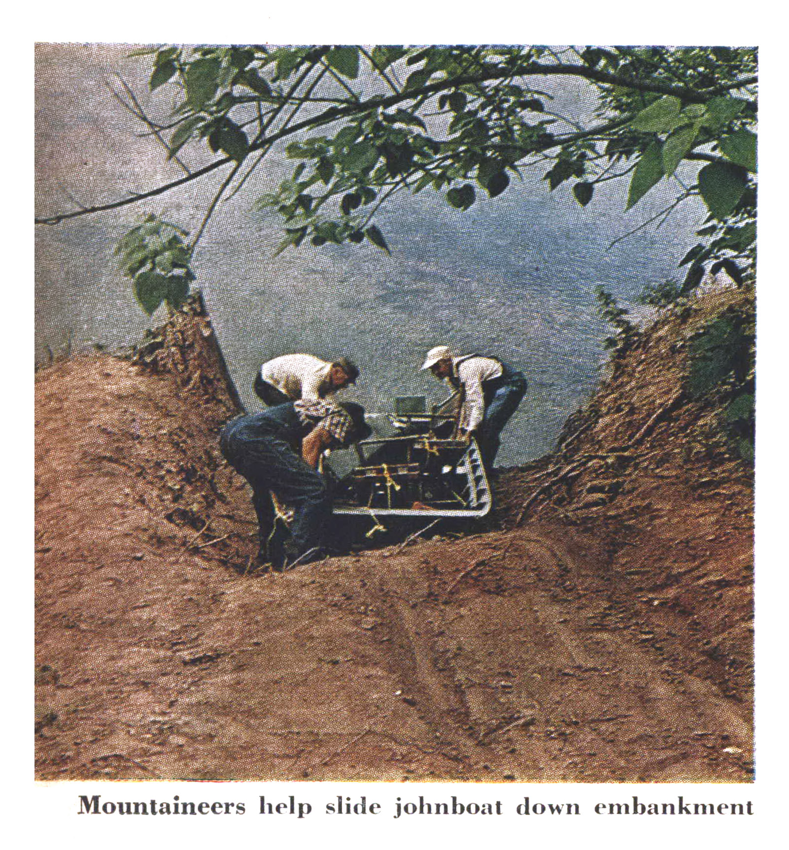 An old color photograph of men launching a boat.
