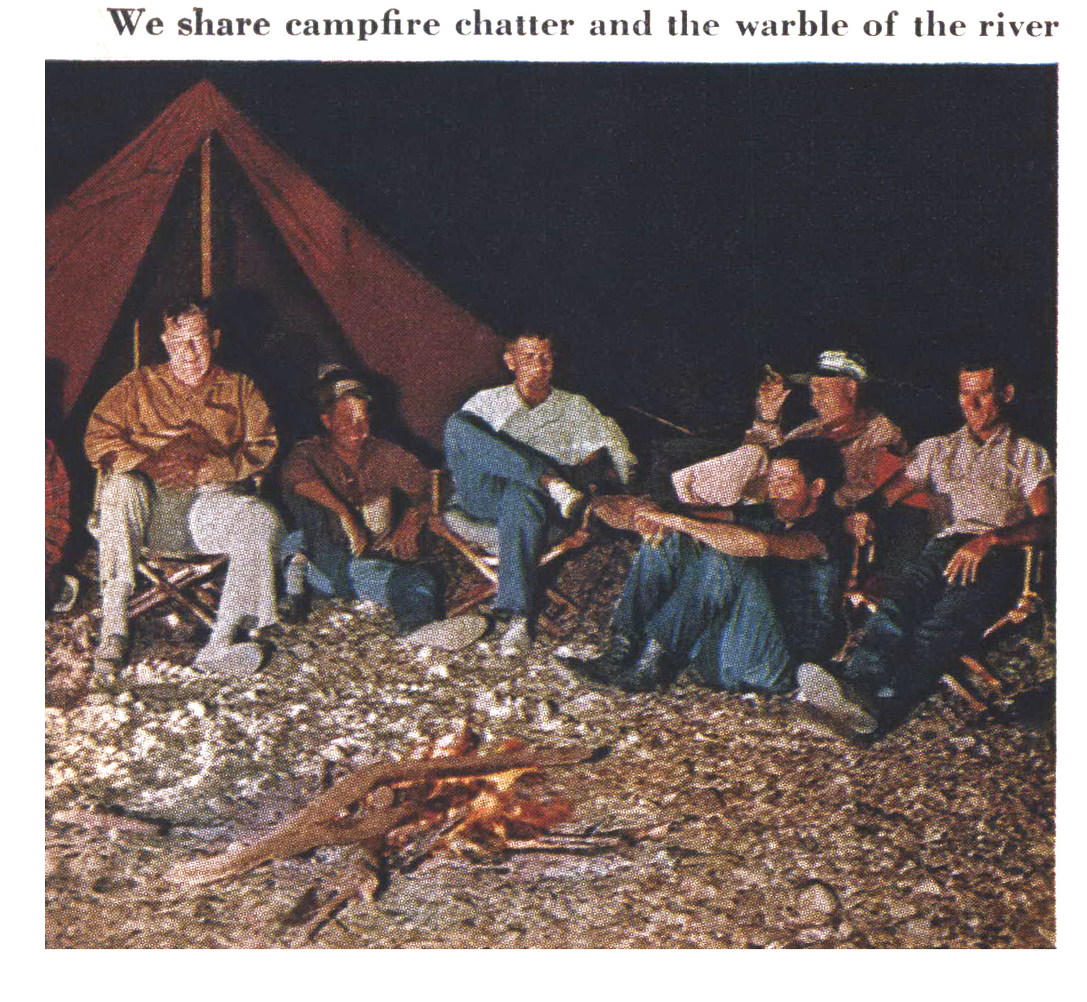 An old color photograph of men sitting in front of a canvas tent.